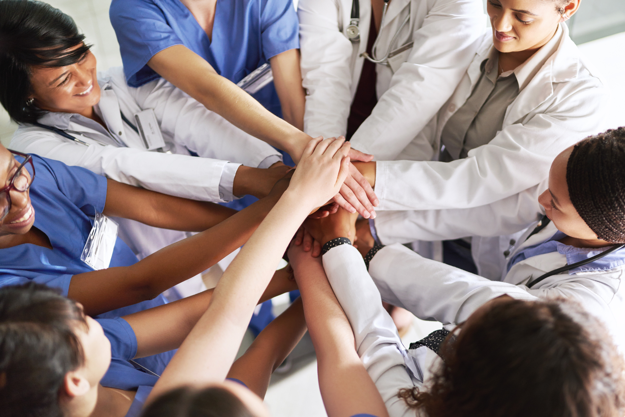 A team of doctors and nurses in a huddle